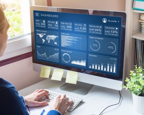 Digital marketing campaign data analytics report with metrics and key performance indicators (KPI) on information dashboard for advertisement strategy on internet, business person in office